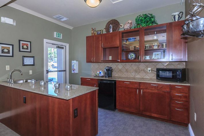 a community kitchen with wooden cabinets