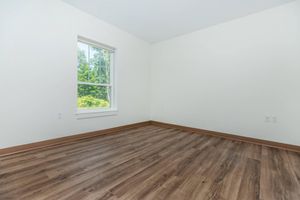 a bedroom with a wooden floor