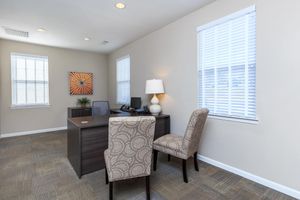 a living room filled with furniture and a large window