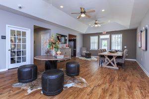 a living room filled with furniture on top of a hard wood floor