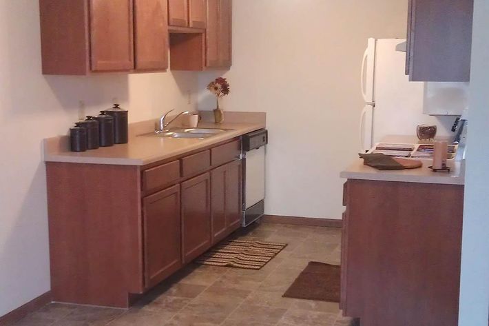 a kitchen with a sink and a refrigerator