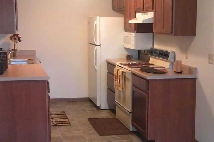 a kitchen with a stove top oven sitting inside of a refrigerator