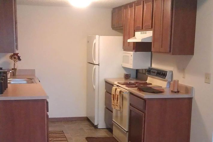 a kitchen with a stove top oven sitting inside of a refrigerator