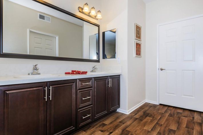 a large kitchen with stainless steel appliances and wooden cabinets