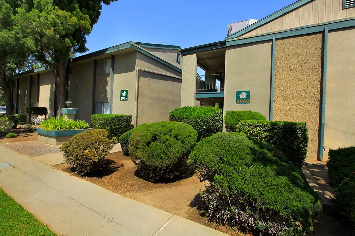 two story apartment building with landscaping.