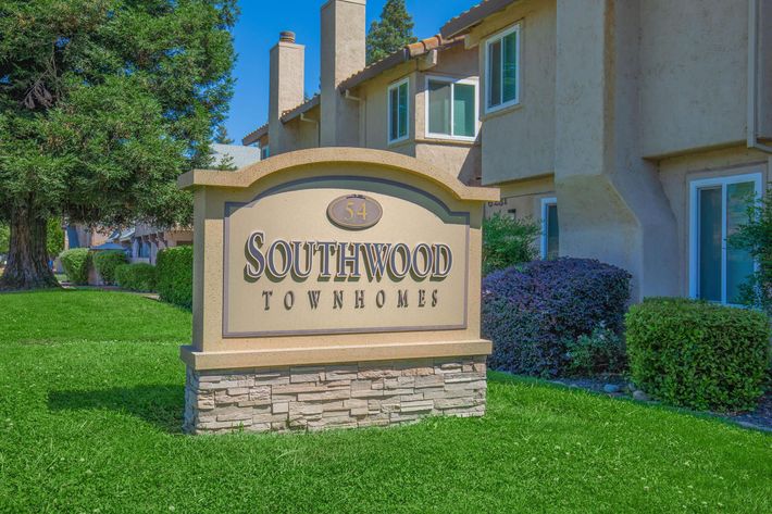 a sign in front of a brick building