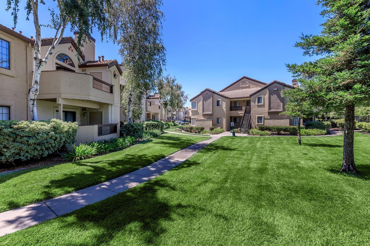 a house with a lawn in front of a building