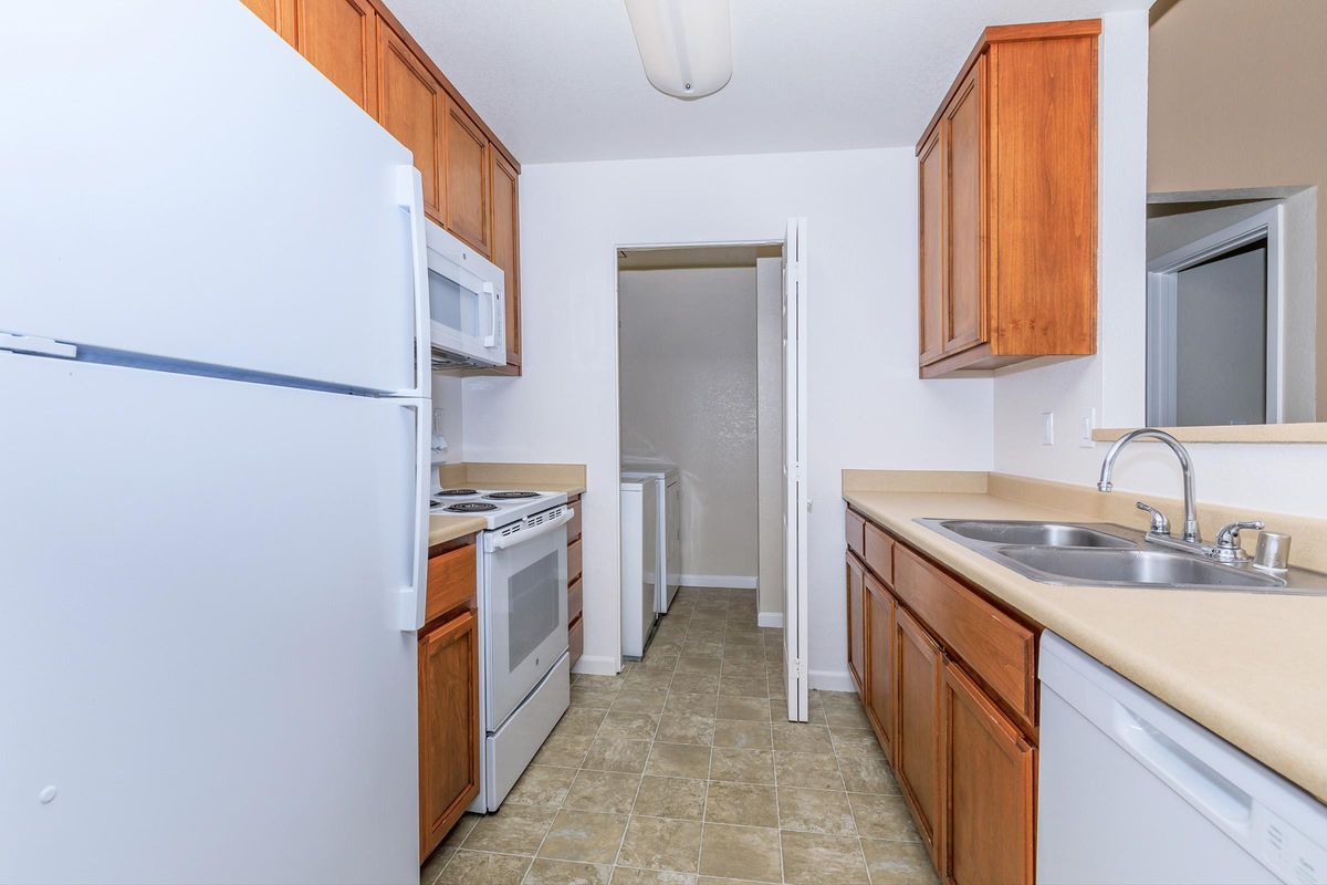 a kitchen with a sink and a refrigerator