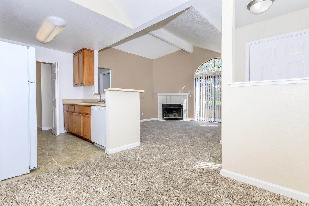 a kitchen with a refrigerator in a room