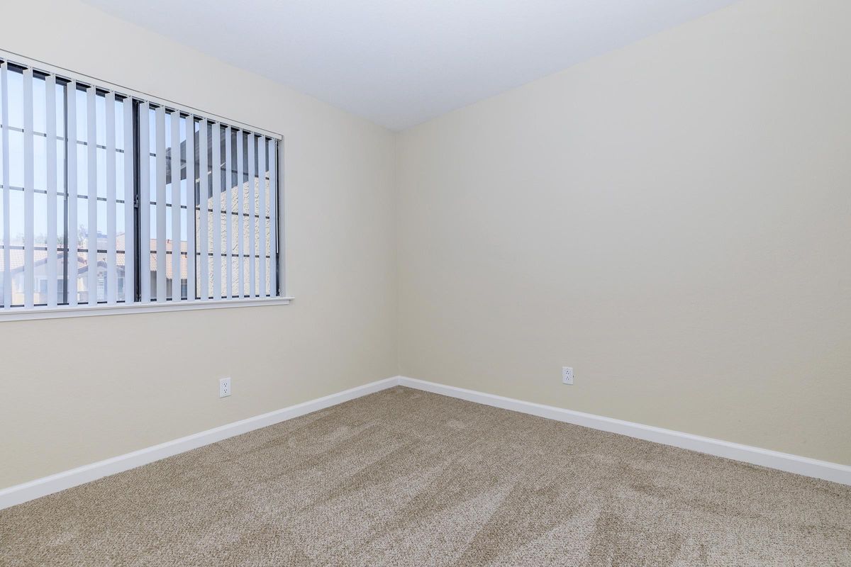 a bedroom with a large window