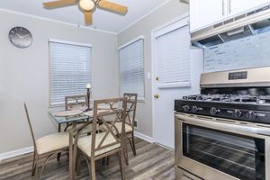 a stove top oven sitting inside of a kitchen