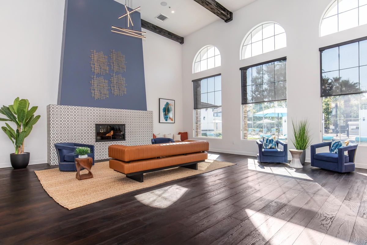 a living room filled with furniture and a large window