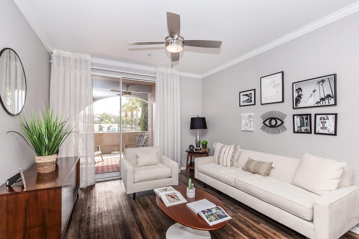 a living room filled with furniture and a flat screen tv