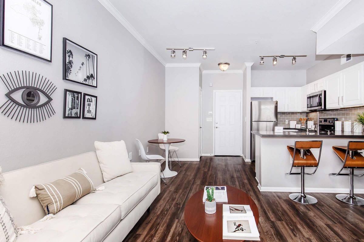 a living room filled with furniture and a flat screen tv