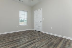 a bedroom with a wooden floor