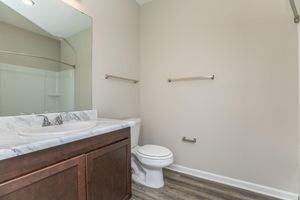 a bedroom area with a sink and a mirror