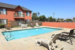 a house with a pool outside of a building