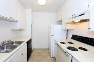 a white stove top oven sitting inside of a kitchen