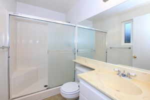 a large white tub next to a glass shower door