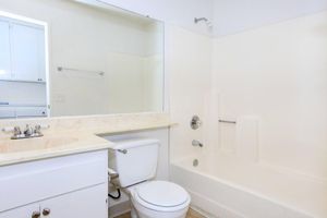 a white tub sitting next to a sink