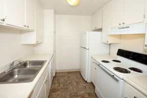 a white stove top oven sitting inside of a kitchen