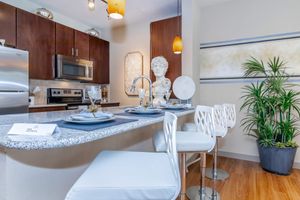 a kitchen with a table in front of a window