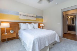 a bedroom with a bed and desk in a hotel room