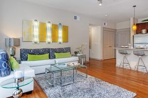 a living room filled with furniture and a flat screen tv