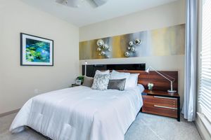 a bedroom with a large bed in a hotel room