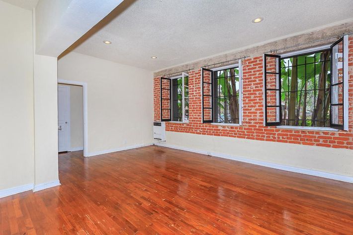 a large empty room with a wood floor