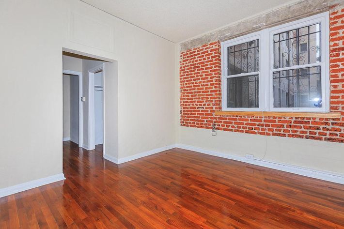 a large empty room with a wood floor