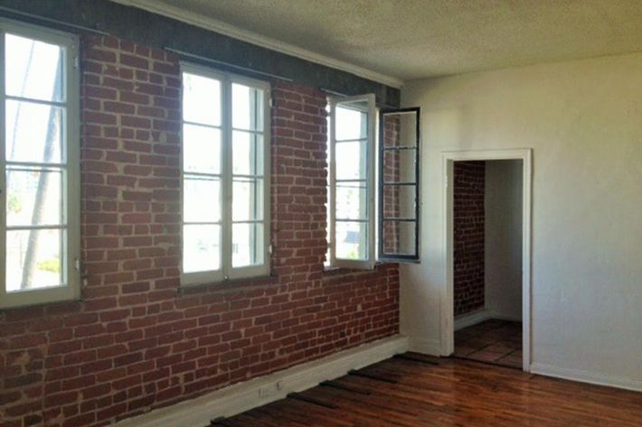 a room with brick walls and a large window