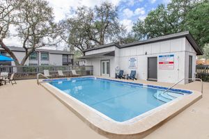 a house with a pool in front of a building