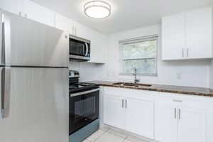 a kitchen with a stove and a refrigerator