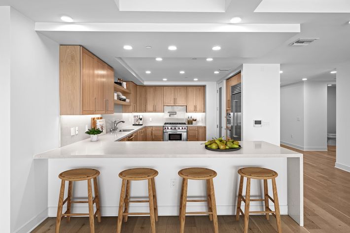 a kitchen with wooden cabinets and a dining room table