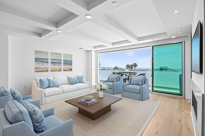 a living room filled with furniture and a large window