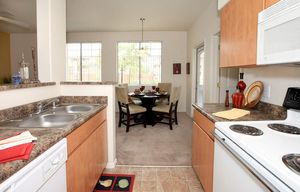a kitchen with a stove a sink and a window