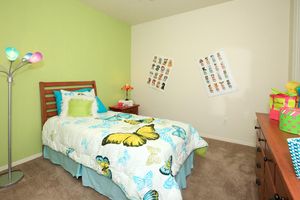 a bedroom with a bed in a room