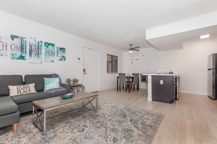 a living room filled with furniture and a flat screen tv