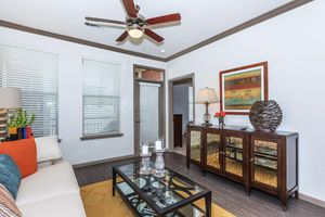 a living room filled with furniture and a large window