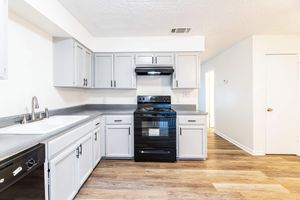 a kitchen with a stove and a refrigerator