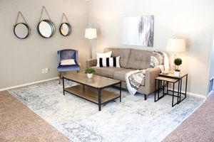 a living room filled with furniture and a table