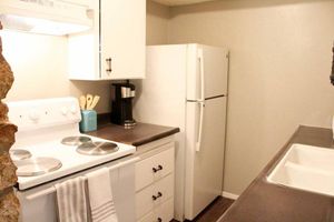 a kitchen with a sink and a mirror