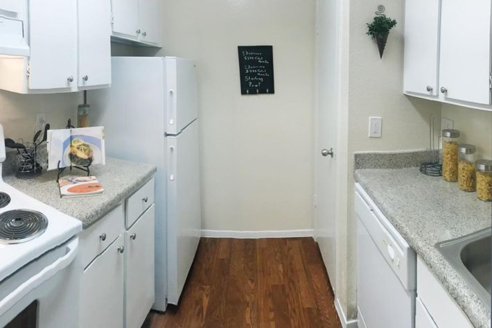 a white stove top oven sitting inside of a kitchen