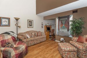 a living room filled with furniture and a flat screen tv