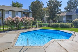 a house with a pool in front of a building