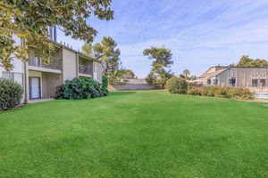 a green lawn in front of a house