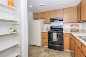 a kitchen with a stove and a refrigerator