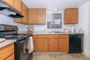 a kitchen with a stove oven and refrigerator