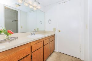 a kitchen with a sink and a mirror